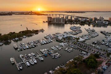 Aerial view of Sarasota city downtown at sunset with bay marina yachts and high-rise office...
