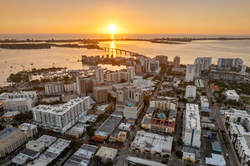Aerial view of Sarasota city downtown at sunset with high-rise office buildings and Ringling Bridge on horizon. Real estate development in Florida. USA travel destination © bilanol