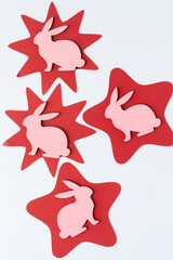 abstract red stars and pink bunny shapes on paper