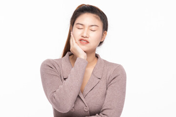Young Asian woman in brown blazer holding her cheek, expressing pain from a severe toothache