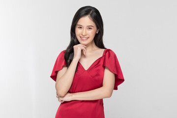 Charming young woman with a thoughtful pose wearing a chic red dress, white background