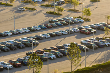 Large parking lot of local dealer with many brand new cars parked for sale. Development of american automotive industry and distribution of manufactured vehicles concept © bilanol