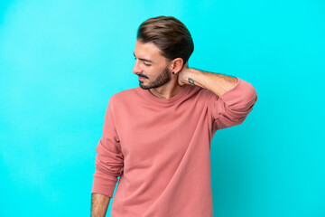 Young caucasian man isolated on blue background with neckache