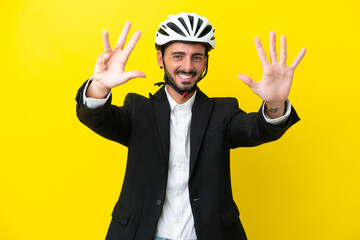 Business caucasian man with a bike helmet isolated on yellow background counting nine with fingers