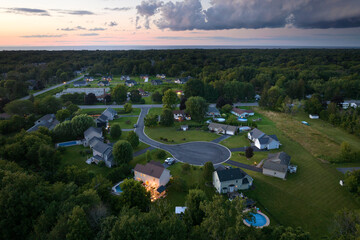 Residential illuminated homes at sunset in suburban sprawl development in Rochester, New York....