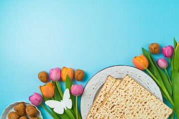 Jewish holiday Passover concept with matzah and  spring tulip flowers on blue  background. Top view, flat lay composition - 759873437