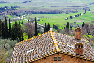 Beautiful landscape of Tuscany's green hills at the picturesque Val d' Orcia, near Siena and Florence, with natural light, cypresses and endless fields. 