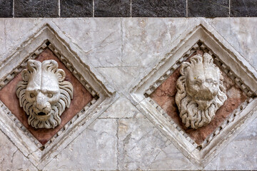 Lions head sculptured at the facade of the Baptistry of St. John (Battistero di San Giovanni) in Siena, Tuscany, Italy, Europe. 
