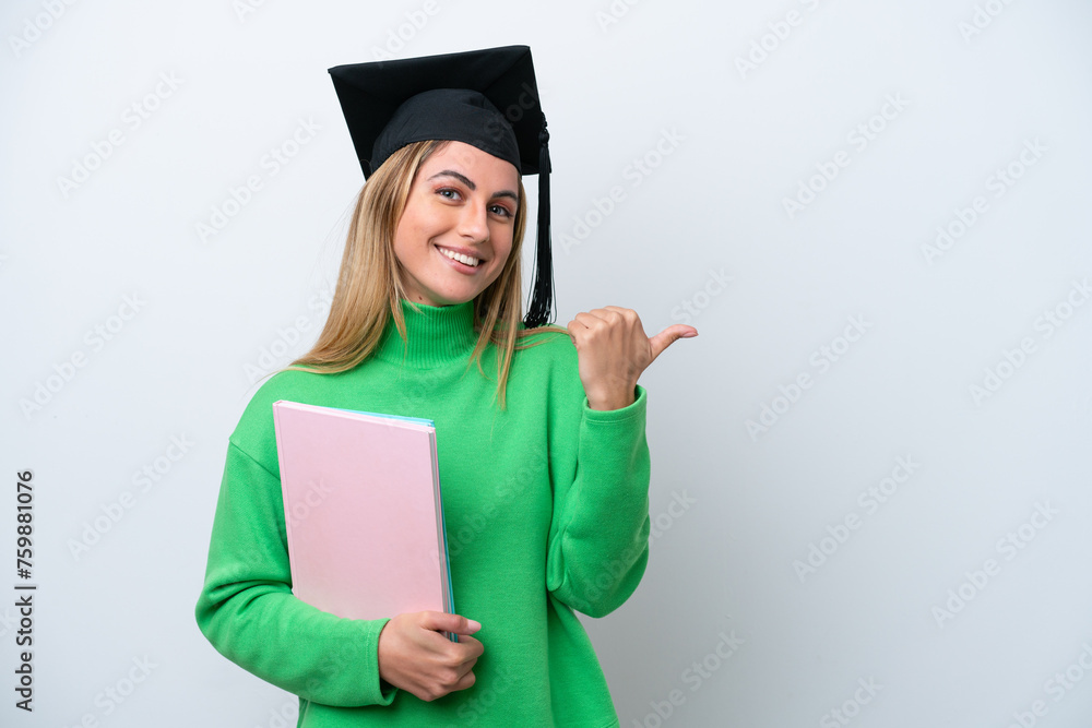 Canvas Prints young university graduate woman isolated on white background pointing to the side to present a produ