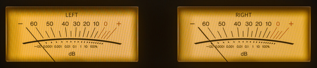 Audio Dual Volume Unit Meters Glowing in the Dark with Yellow and Orange Hues.