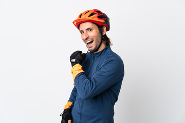 Young cyclist man isolated on white background celebrating a victory - obrazy, fototapety, plakaty