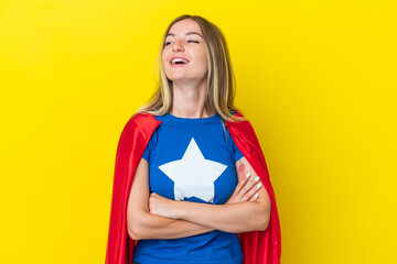 Super Hero Romanian woman isolated on yellow background happy and smiling