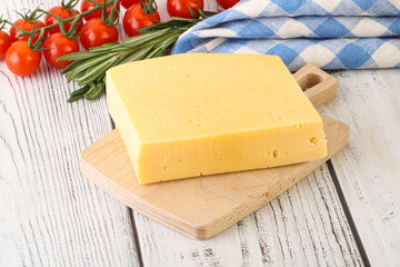 Piece of natural organic cheese over board