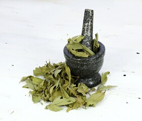 Dried lovage, famous culinary herb, lat. Levisticum officinale. Dried lovage in a mortar with...