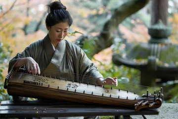 Zelfklevend Fotobehang Japanese woman playing the harp in Kyoto Japan.  © PixelGallery