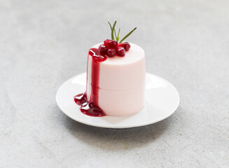 Modern dessert. Pomegranate Panna Cotta with pomegranate sauce. On a plate. Close-up