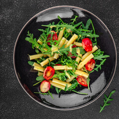 pasta salad tomato, arugula, boiled pasta fresh food tasty healthy eating cooking appetizer meal food snack on the table copy space food