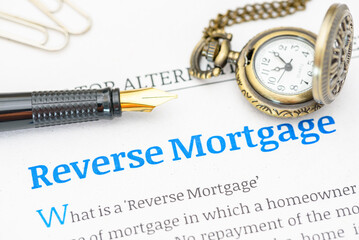 Fountain pen on a reverse mortgage document. A reverse mortgage is a loan for homeowners, converting home equity into cash. Repayment is typically deferred until the owner moves out or passes away.