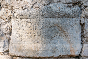 Relief text in ancient Greek in the ancient city of Olympos in Turkey.