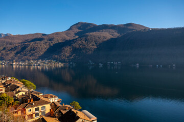 Cityscape and Lake Lugano with Blue Sky and Mountain in a Sunny Day in Morcote, Ticino in...