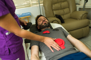 Therapist doing magnet therapy at the alternative medicine clinic