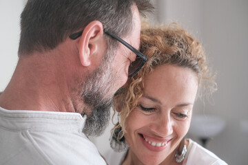 Portrait of lovely mature family Caucasian couple hugging each other tenderly, exchanging cuddles...