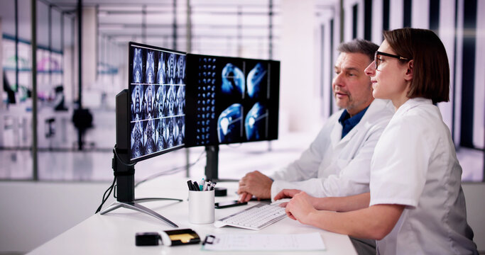 Doctors Looking At An MRI Scan At Computer