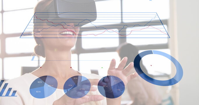 Image of statistical data processing over caucasian woman wearing vr headset at office