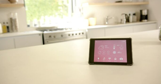 A smart home interface sits on a kitchen counter, copy space