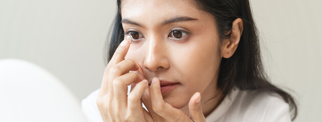 Optimise vision by contact lens, Close-up of woman face during insert contact lens to her eyes.