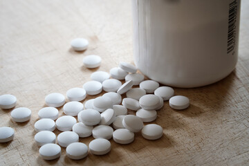 Fototapeta na wymiar Plastic medicine bottle and white capsule pills out, medicine and health concept