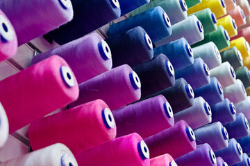 Assorted spools of multi-coloured cotton threads