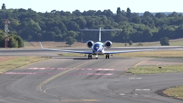 High End Business Corporate Private Jet Airplane Aircraft Taxiing Head On at Executive Airport