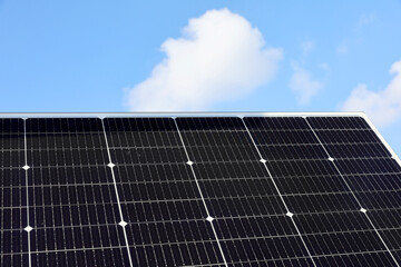 Solar panels against blue sky in a solar energy power plant used to produce electricity from the sunlight. Clean and renewable energy, power in nature.