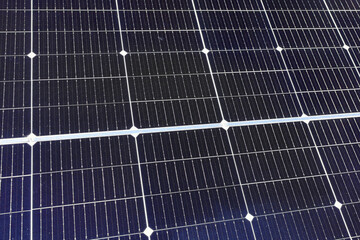 Solar panels closeup in a solar energy power plant used to produce electricity from the sunlight. Clean and renewable energy, power in nature.
