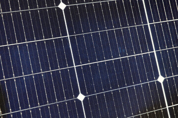 Solar panels closeup in a solar energy power plant used to produce electricity from the sunlight. Clean and renewable energy, power in nature.