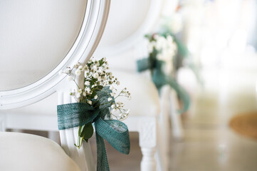 Details of the decoration of the chairs at a civil wedding ceremony.
