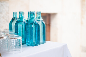Several bottles of water ready to serve in a restaurant at a celebration event.