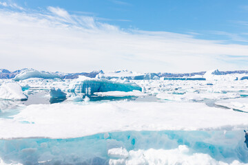 Fototapeta na wymiar Melting of a iceberg and pouring water into the sea - Greenland - Tiniteqilaaq, Sermilik Fjord, East Greenland