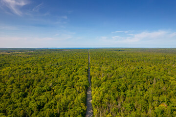 Misery Bay road aerial view from above. Nature and green space on Manitoulin Island. Travel and adventure lifestyle of tranquility and outdoor adventure. Wilderness and ecological haven in Canada.