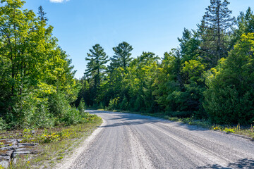 Gravel off road to Blue Jay Creek with Michael's Bay, Lake Huron, Manitoulin Island, unveils a...