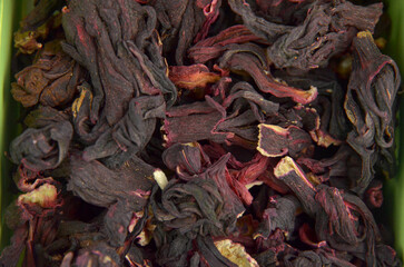 Egyptian hibiscus dry red tea (karkade) background, closeup (macro), top view