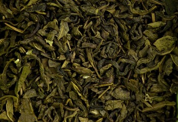 Dry green leaf tea background, closeup (macro), top view