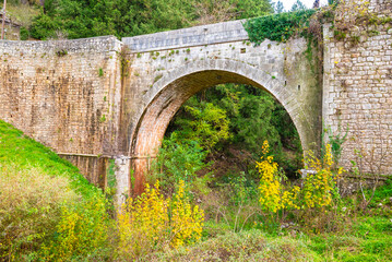 Fototapeta na wymiar The stone bridge at the entrance of Dimitsana village in Peloponnese, Arcadia, Greece