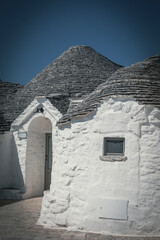 The typical Trulli of Alberobello. Medieval white stone houses created to protect from the heat of...