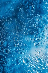 Microscopic water bubbles create a fascinating pattern on a blue surface.