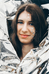woman as a fantasy portrait with tacks in her face and a silver foil