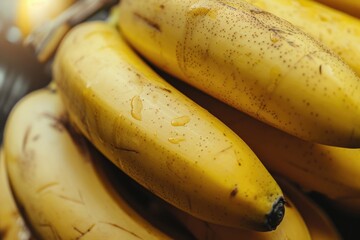 A bunch of ripe bananas with a focus on their bright yellow curves and dark tips, showing the smooth texture and natural imperfections on the skins.