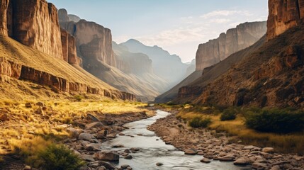 A spectacular landscape of a canyon with mountains rising in the background - obrazy, fototapety, plakaty