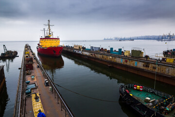 Icebreaker ship enters floating dock, marine engineering prowess. Vessel maintenance at shipyard,...